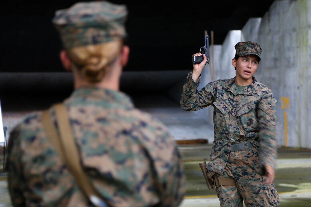 Lance Cpl Jeanette Martinez, a Marine with 2nd Law Enforcement Battalion attached to the Female Engagement Team (FET), 26th Marine Expeditionary Unit (MEU), conducts a marksmanship training class during Realistic Urban Training (RUT) at Stone Bay, N.C., Aug. 24, 2017.