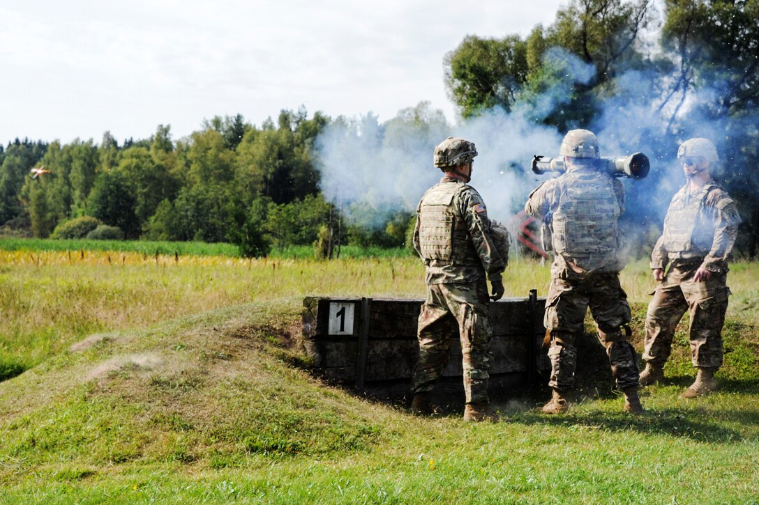 Soldiers fire an AT-4 rocket launcher during weapons familiarization