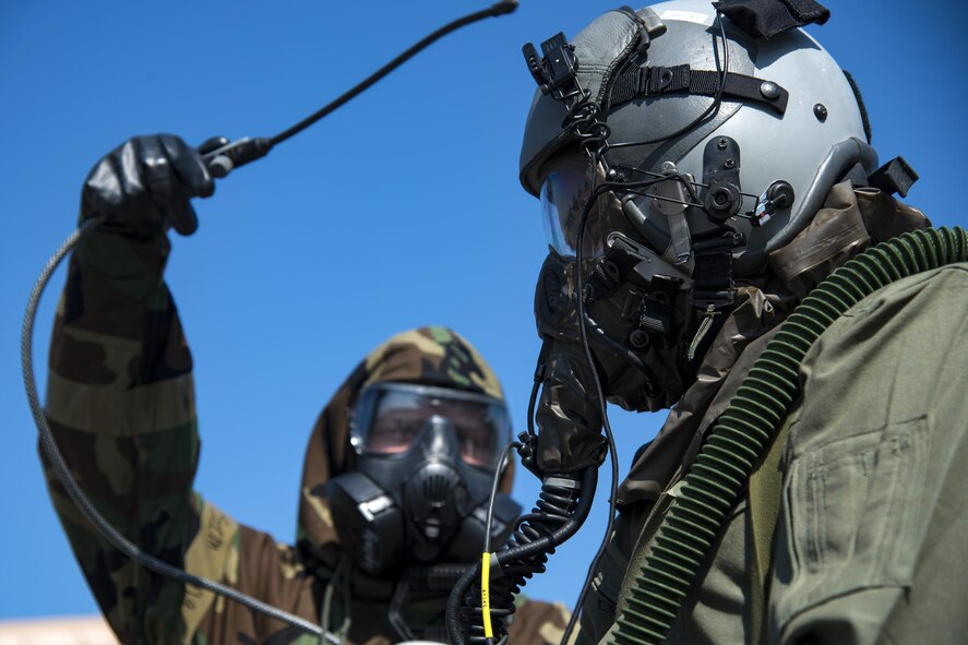 An aircrew flight equipment technician from the 347th Operations Support Squadron, left, simulates spraying down Capt. Chisom Ezeoke, 71st Rescue Squadron combat systems officer, during Aircrew Contamination Control Area training, Aug. 24, 2017, at Moody Air Force Base, Ga. ACCA training teaches aircrew how to remove and properly handle any contamination on their gear. (U.S. Air Force photo by Airman 1st Class Erick Requadt)