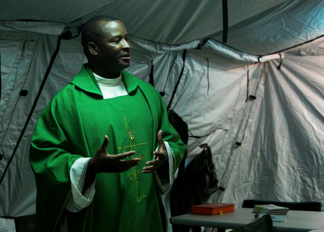 U.S. Navy Lt. Takana L. Jefferson, a chaplain with Battalion Landing Team (BLT) 2nd Battalion, 6th Marine Regiment, 26th Marine Expeditionary Unit (MEU), gives a sermon to Marines as part of religious services during Realistic Urban Training at Camp Davis Training Area, N.C., Aug. 20, 2017.