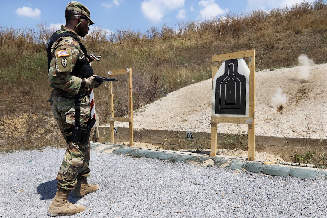 Army Sgt. Javon Gray fires two rounds from his 9mm pistol at a close target
