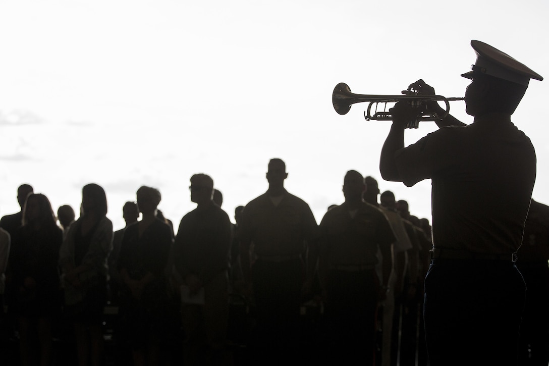 Lance Cpl. Christian Rosario, a bugler with Marine Corps Band New Orleans, performs “Taps” during the end of a memorial honoring nine Marines of Marine Aerial Refueler Transport Squadron 452, Marine Aircraft Group 49, 4th Marine Aircraft Wing, Marine Forces Reserve, at Stewart Air National Guard Base in Newburgh, New York, Aug. 27, 2017.