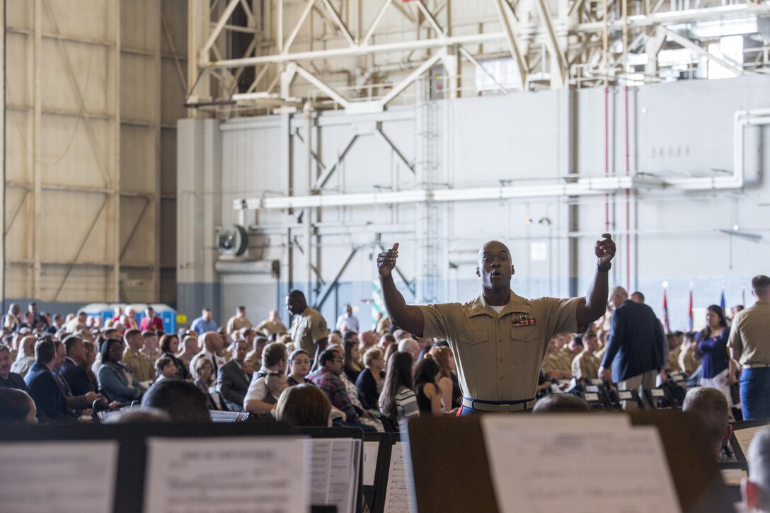 Chief Warrant Officer 2 DeMarius Jackson, band officer of Marine Corps Band New Orleans, conducts the band during a memorial service at Stewart Air National Guard Base in Newburgh, New York, Aug. 27, 2017.