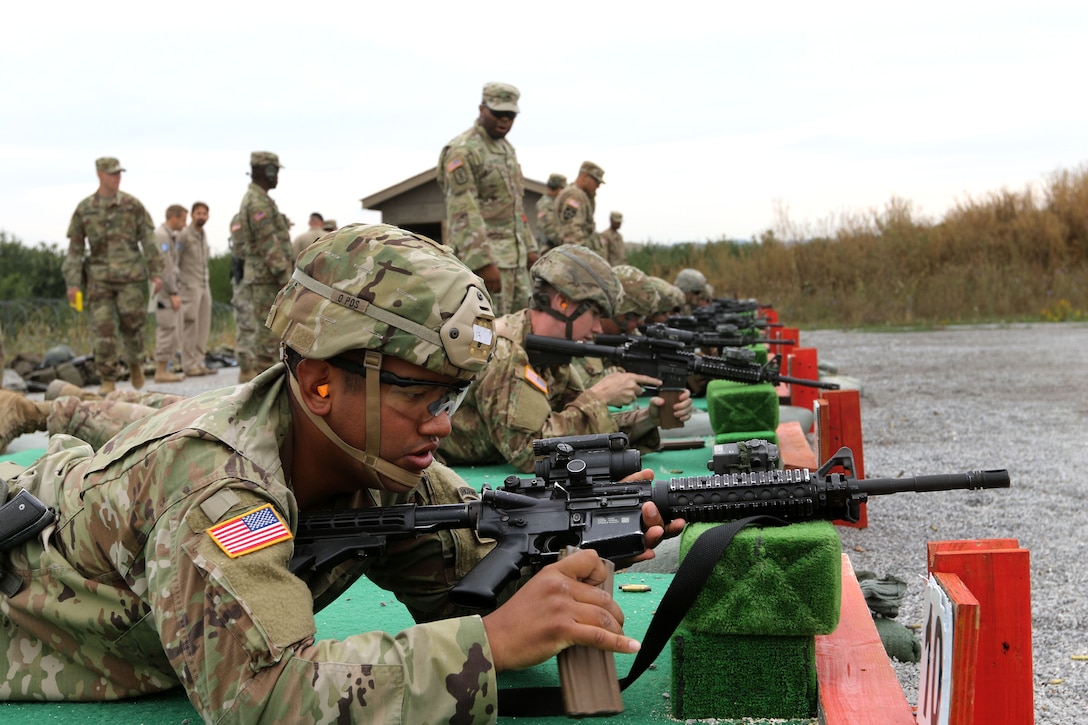 Soldiers load their M4 carbines before firing on the range
