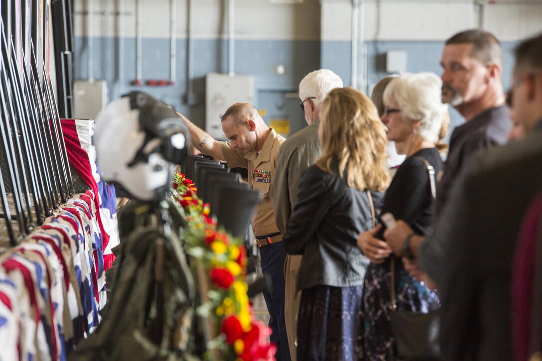 Sergeant Maj. Larry Liechty, sergeant major of Marine Aircraft Group 49, 4th Marine Aircraft Wing, Marine Forces Reserve, pays his respects to nine Marines of Marine Aerial Refueler Transport Squadron 452, 4th MAW, MARFORRES, following a memorial at Stewart Air National Guard Base, Aug. 27, 2017.