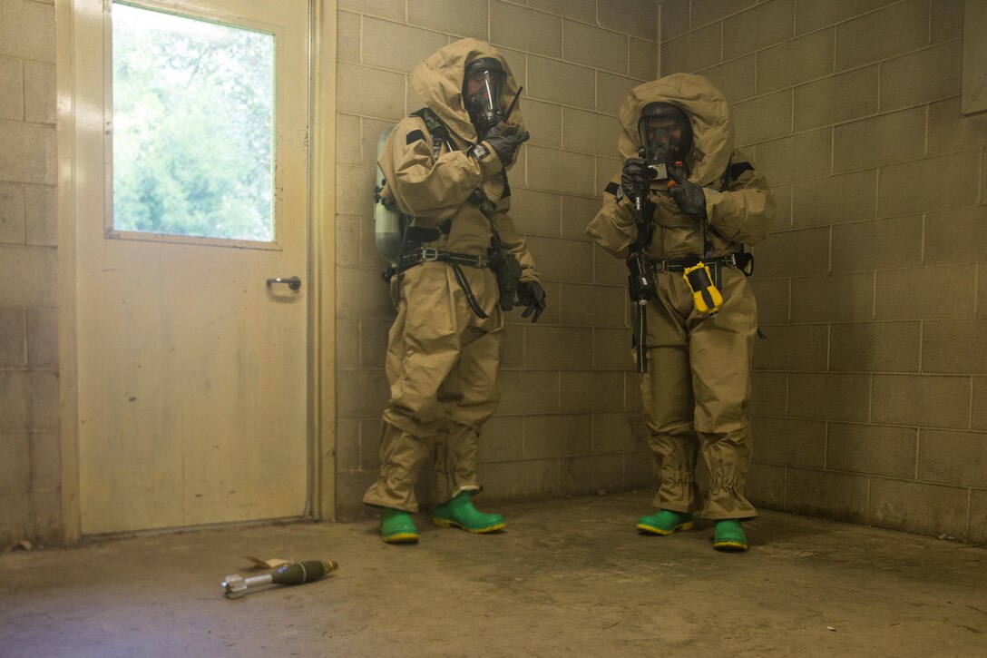 U.S. Marine Corps Cpl. Efrain H. GonzalezOrtiz, right, and Cpl. James L. Ellison III, both chemical, biological, radiological, nuclear defense specialists with the 26th Marine Expeditionary Unit (MEU), document and report an 60mm mortar round during assessment and consequence management training at Camp Geiger, N.C., Aug. 18, 2017.