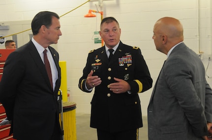 Maj. Gen. Troy D. Kok, commanding general of the U.S. Army Reserve’s 99th Regional Support Command, speaks with U.S. Congressman Thomas R. Suozzi and New York City Council Member, 19th District, Queens, Paul A. Vallone at the ribbon-cutting ceremony Aug. 17 for the revitalized AMSA/OMS (Area Maintenance Support Activity/Organizational Maintenance Shop) in Fort Totten. The center underwent a $12.6 million full-facility revitalization, allowing technicians to perform in an up-to-date facility to meet readiness standards as well as train military unit mechanics as needed so they can perform maintenance while they’re deployed.