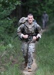 Sgt. Kevin Beuse of Headquarters and Headquarters Company, 470th Military Intelligence Brigade, Joint Base San Antonio-Fort Sam Houston, completes the 12-mile road march event on day three of the U.S. Army Cyber Command Best Warrior Competition Aug. 23.