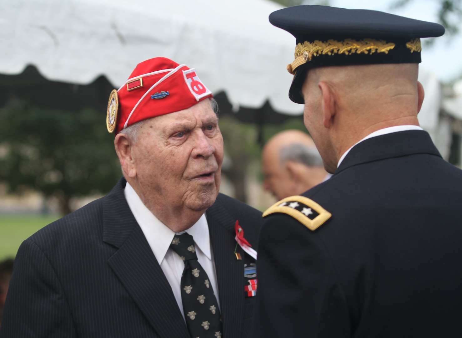 Retired Master Sgt. Vernon Schmidt, a 91-year-old surviving member of the 90th Infantry Division’s from WORLD WAR I I, speaks to Lt. Gen. Jeffrey S. Buchanan, commander of U.S. Army North (Fifth Army) at Joint Base San Antonio-Fort Sam Houston, before the Fort Sam Houston’s World War I Centennial Ceremony honoring the 90th ID inside the historic Quadrangle at Fort Sam Houston, Texas. This year marked the national commemoration for the 100th anniversary of the U.S. entry into World War I , military basses across the U.S. are celebrating their storied unit’s involvement and accomplishments.