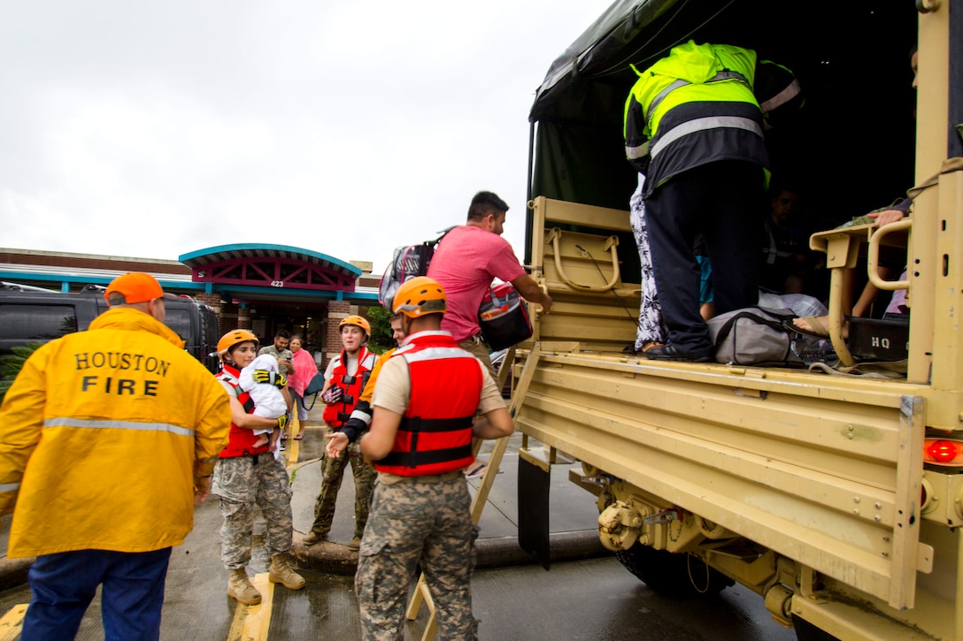 Texas Army National Guardsmen help residents affected by flooding caused by Hurricane Harvey