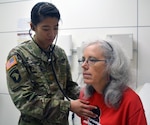 Maj. Amy Yau, an internal medicine physician, listens to Rebecca Haley's heartbeat during a routine checkup Aug. 25 at Brooke Army Medical Center, Joint Base San Antonio-Fort Sam Houston.