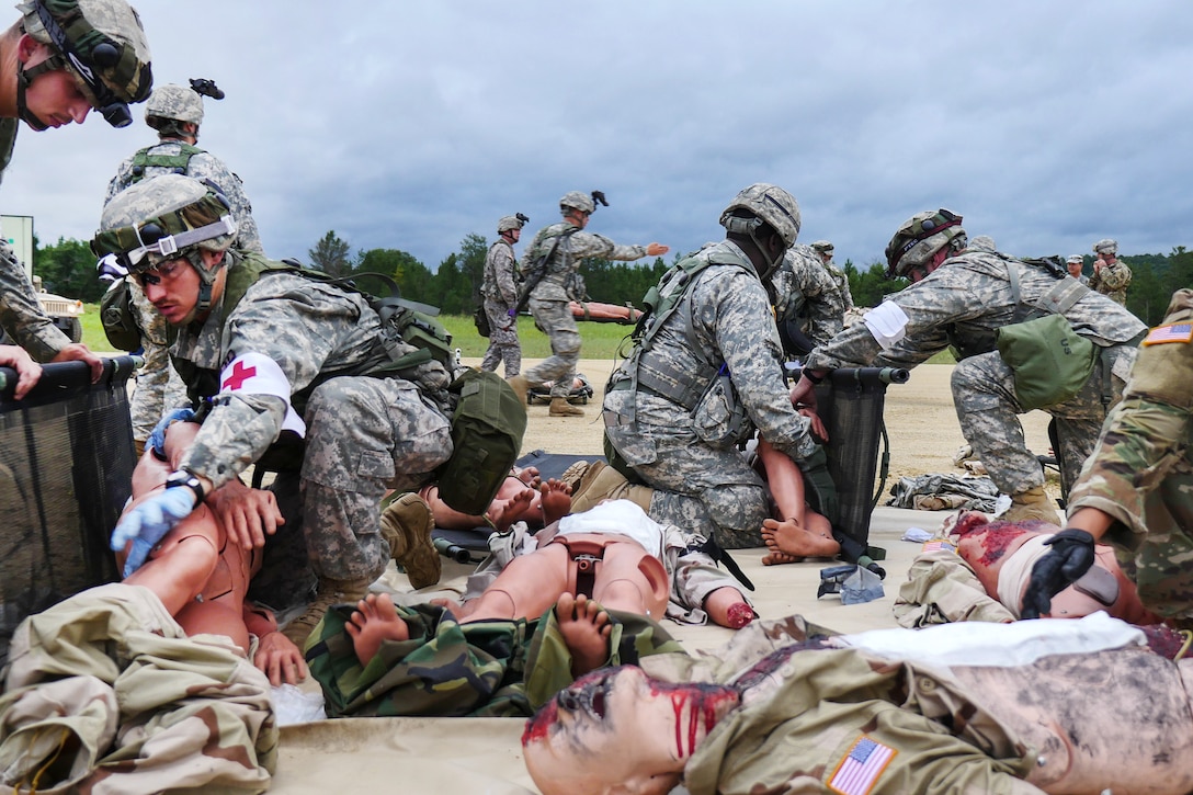 Soldiers provide medical aid to mock victims during a mass casualty training event.
