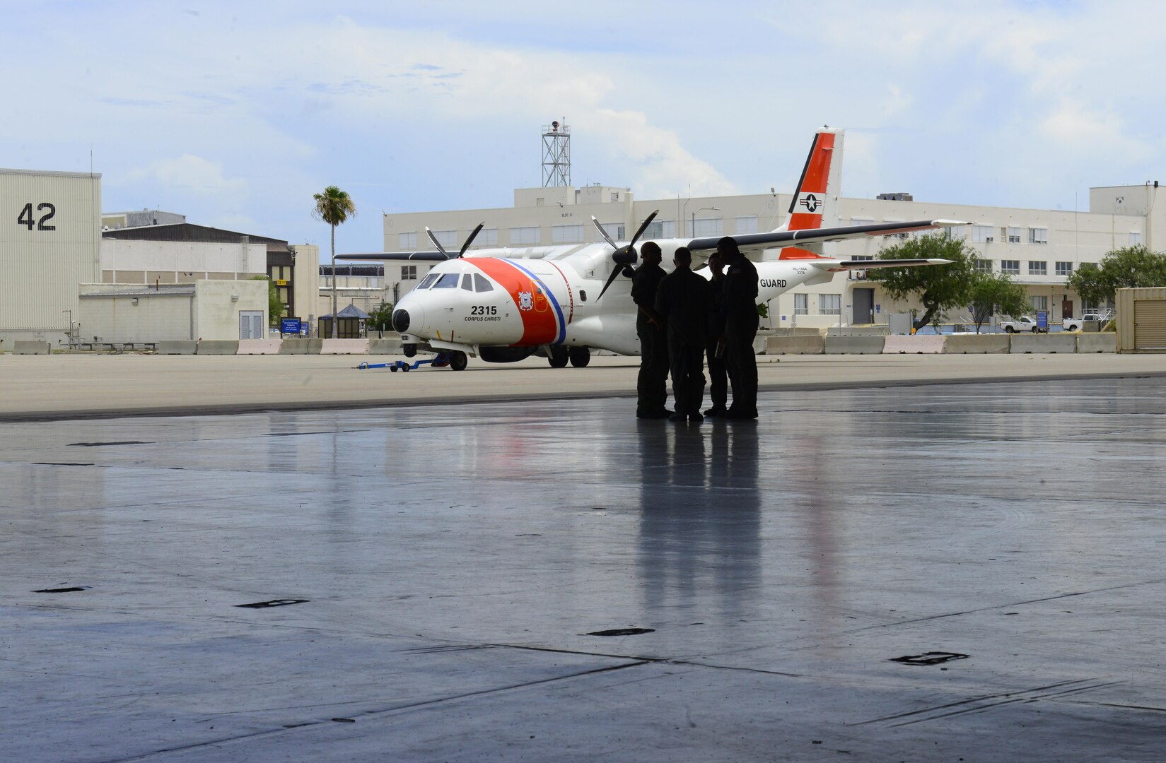 Coast Guard aviation crews discuss flight plans as they prepare for response efforts.