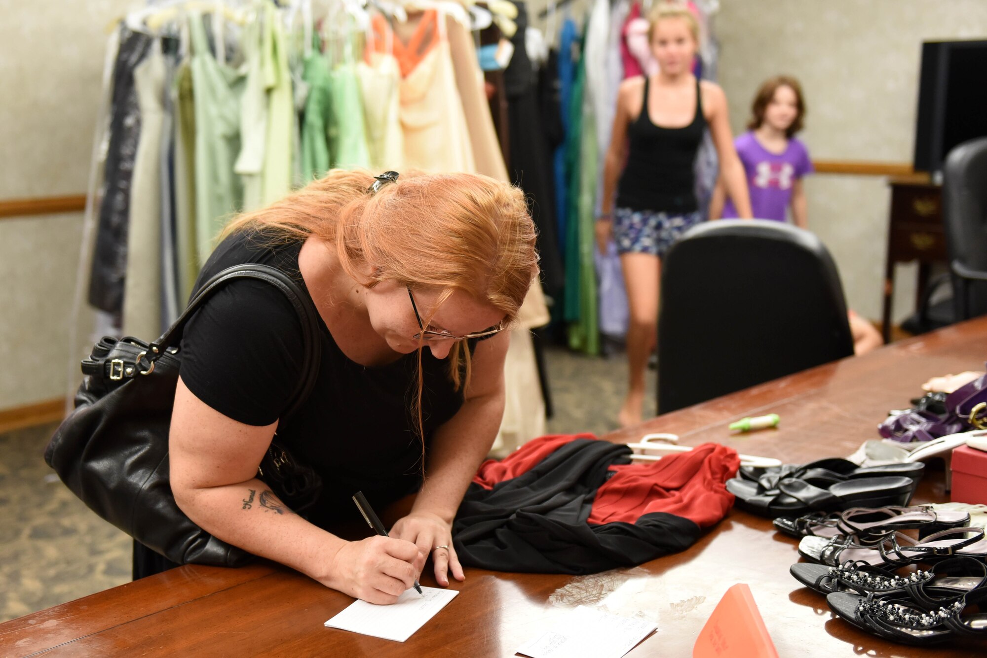 Kimberly Jones fills out a form to borrow a dress from the Cinderella’s Closet program, Aug. 23, 2017, at Seymour Johnson Air Force Base, North Carolina.