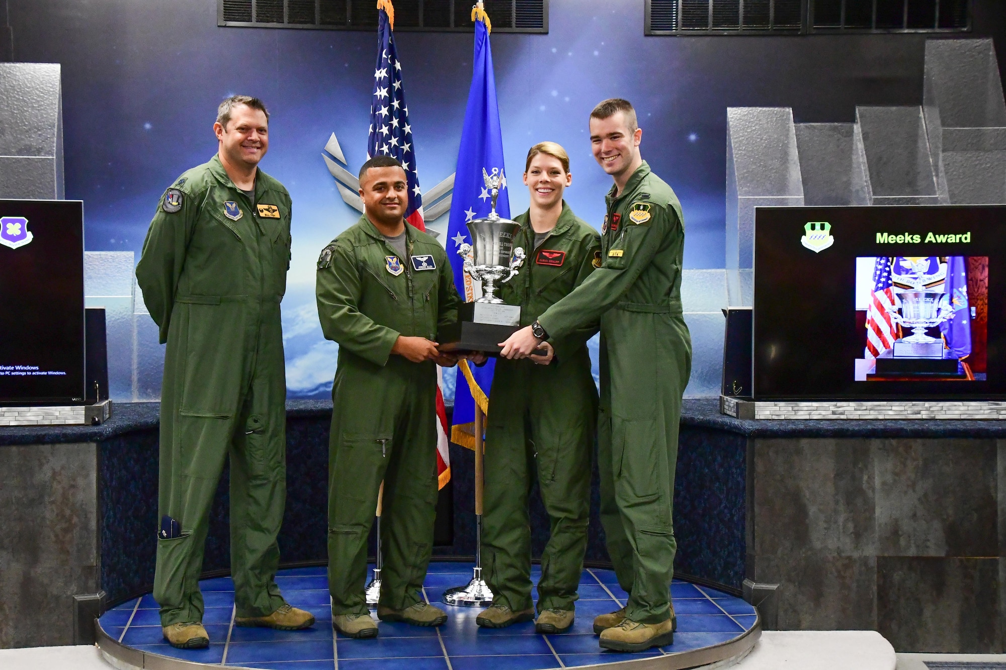 Lt. Col. William Fish, the commander of the 11th Bomb Squadron, presents the Meeks Award to 1st Lt’s. Jordan Alan, Sarah Graupp and Jonathan Morrison during a graduation ceremony on Barksdale Air Force Base, La. Aug. 25, 2017.