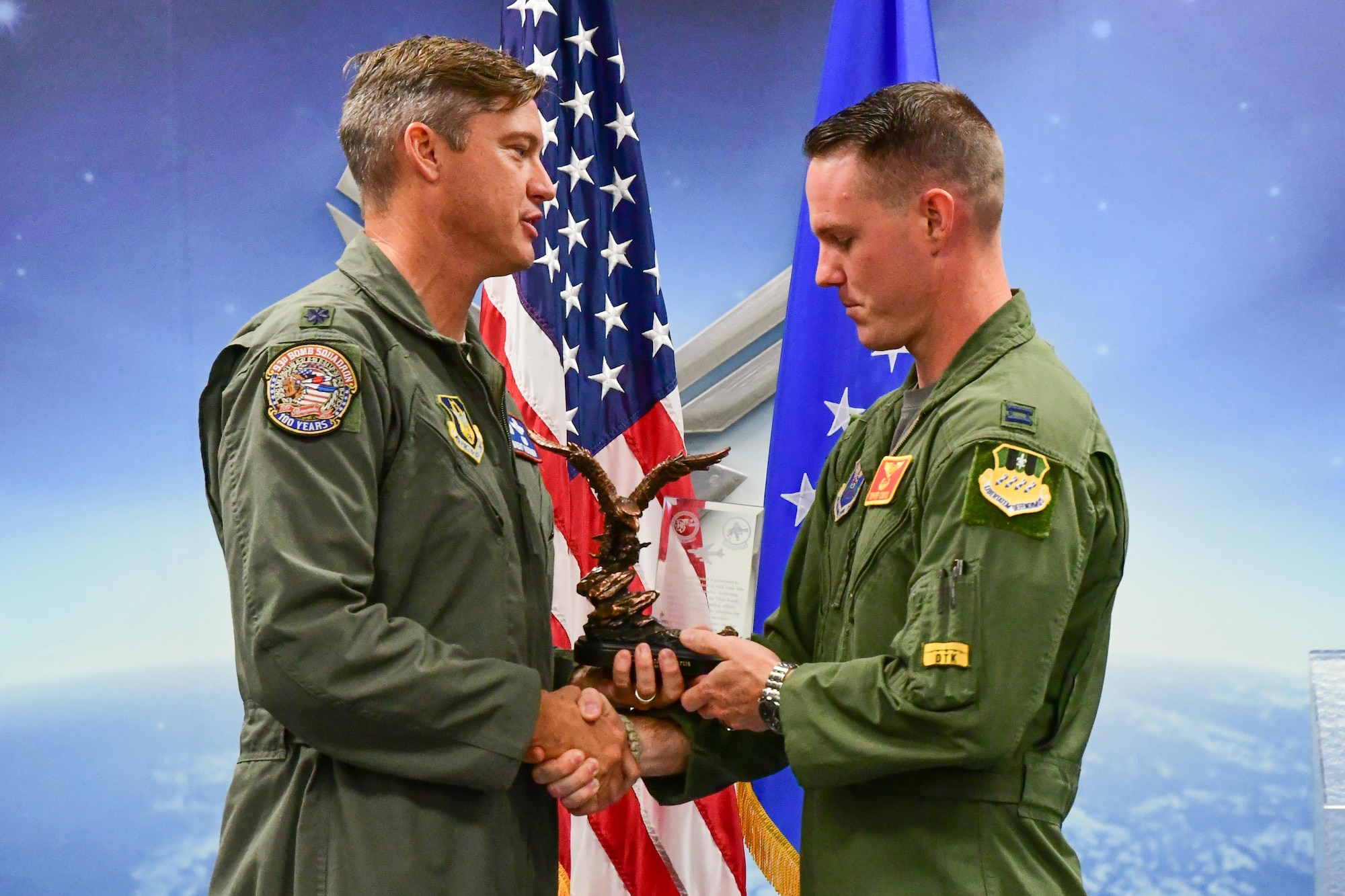Lt. Col. Brent Weisner, the commander of the 93rd Bomb Squadron, presents the Lindell Mabus Leadership Award to Capt. Christopher Curtis during a graduation ceremony on Barksdale Air Force Base, La. Aug. 25, 2017.