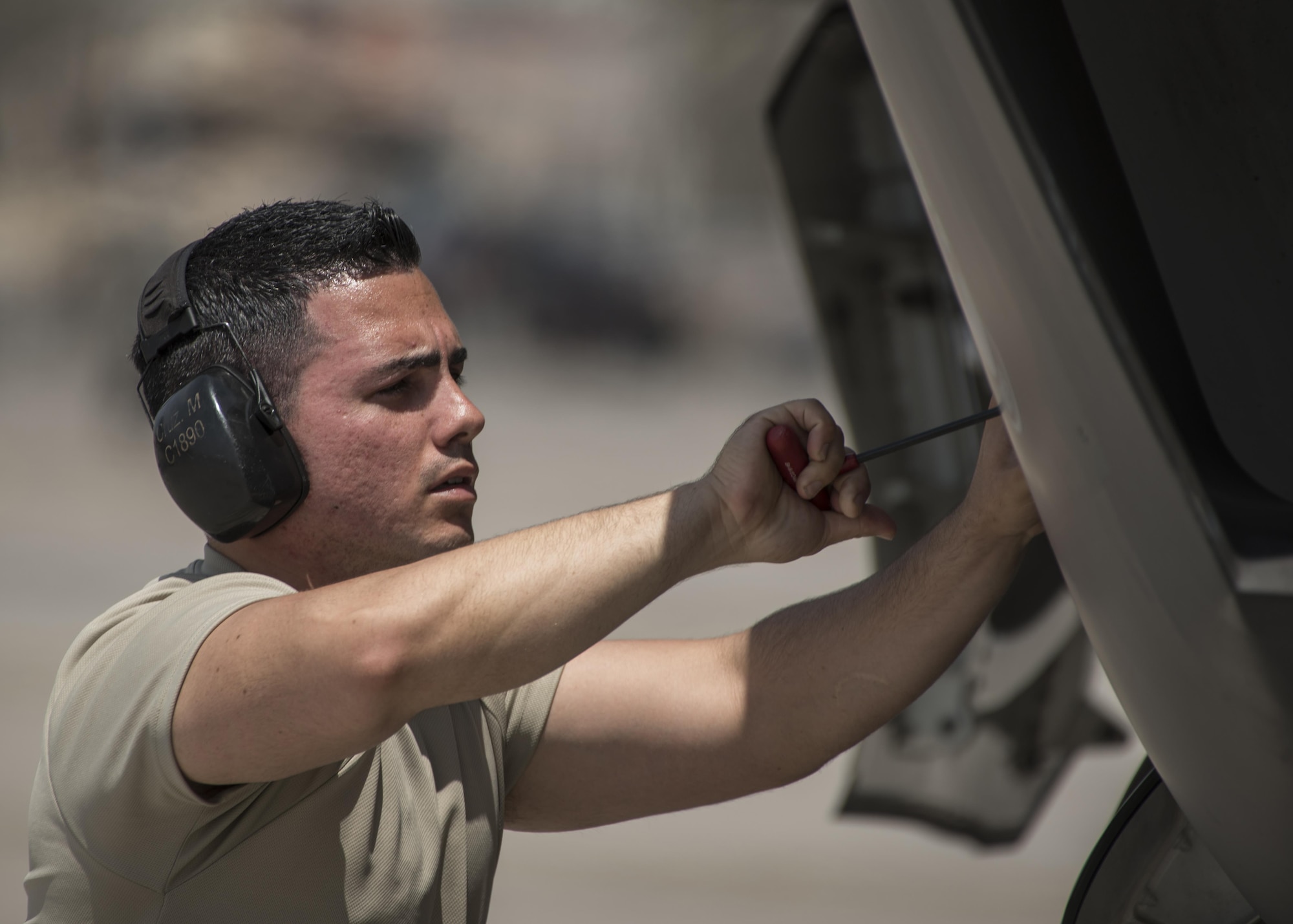 Staff Sgt. Marcos Cruz La Santa, 33rd Aircraft Maintenance Squadron avionics systems technician, closes a maintenance interface panel on an F-35A Lightning II July 18, 2017, at Nellis Air Force Base, Nev. Cruz is one of the first Airmen to become a noncommissioned officer after going through the F-35 training pipeline at Eglin Air Force Base, Fla. Having already experienced the same training first-hand, Cruz and the other core F-35 NCOs are better prepared to lead the fifth generation of aircraft maintainers. (U.S. Air Force photo by Staff Sgt. Peter Thompson)