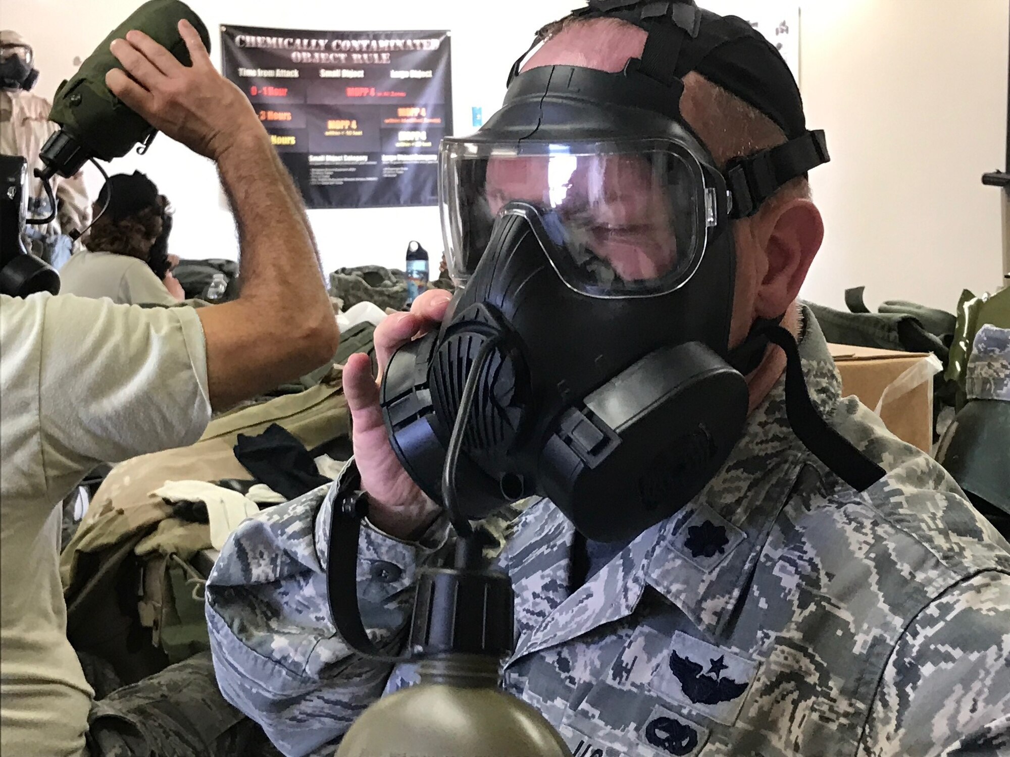 Lt. Col. Joshua Flatley, 940th Operations Support Squadron commander, drinks through his M50 gas mask during chemical, biological, radiological, nuclear, and high-yield explosives training at Beale Air Force Base, California Aug. 12, 2017. This training prepares Citizen Airmen to survive and work in a hostile environments. (U.S. Air Force photo by Staff Sgt. Brenda H. Davis/Released)
