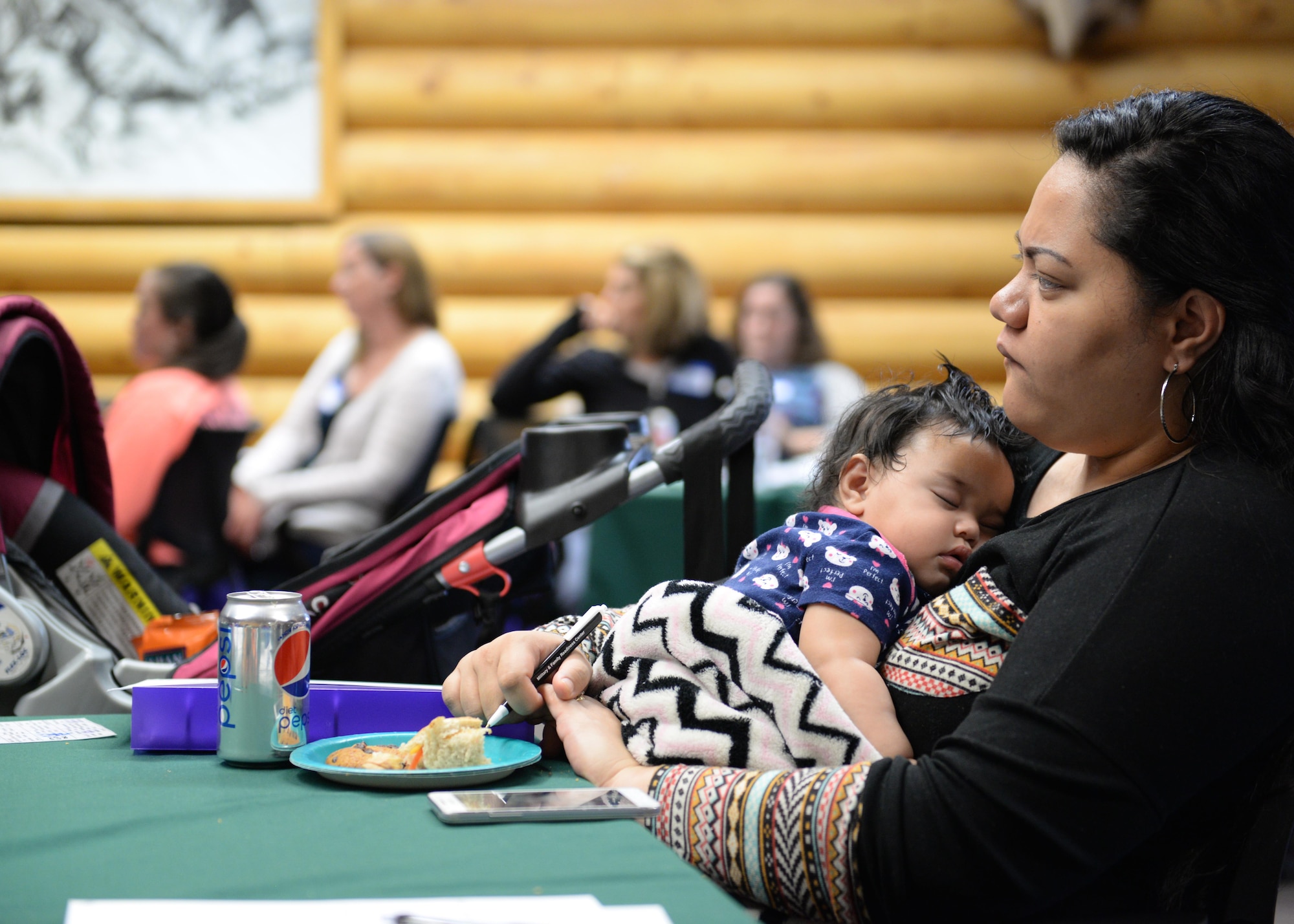 Ululani Tuigamala, spouse of Army Pfc. Sealiitu Tuigamala of the 307th Expeditionary Signal Battalion holds their infant daughter Tamara at the quarterly Joint Spouse Orientation at JBER, Alaska, Aug. 24. The orientation is designed to expose military spouses from all branches of military services to the benefits, programs, opportunities and resources offered specifically at JBER.