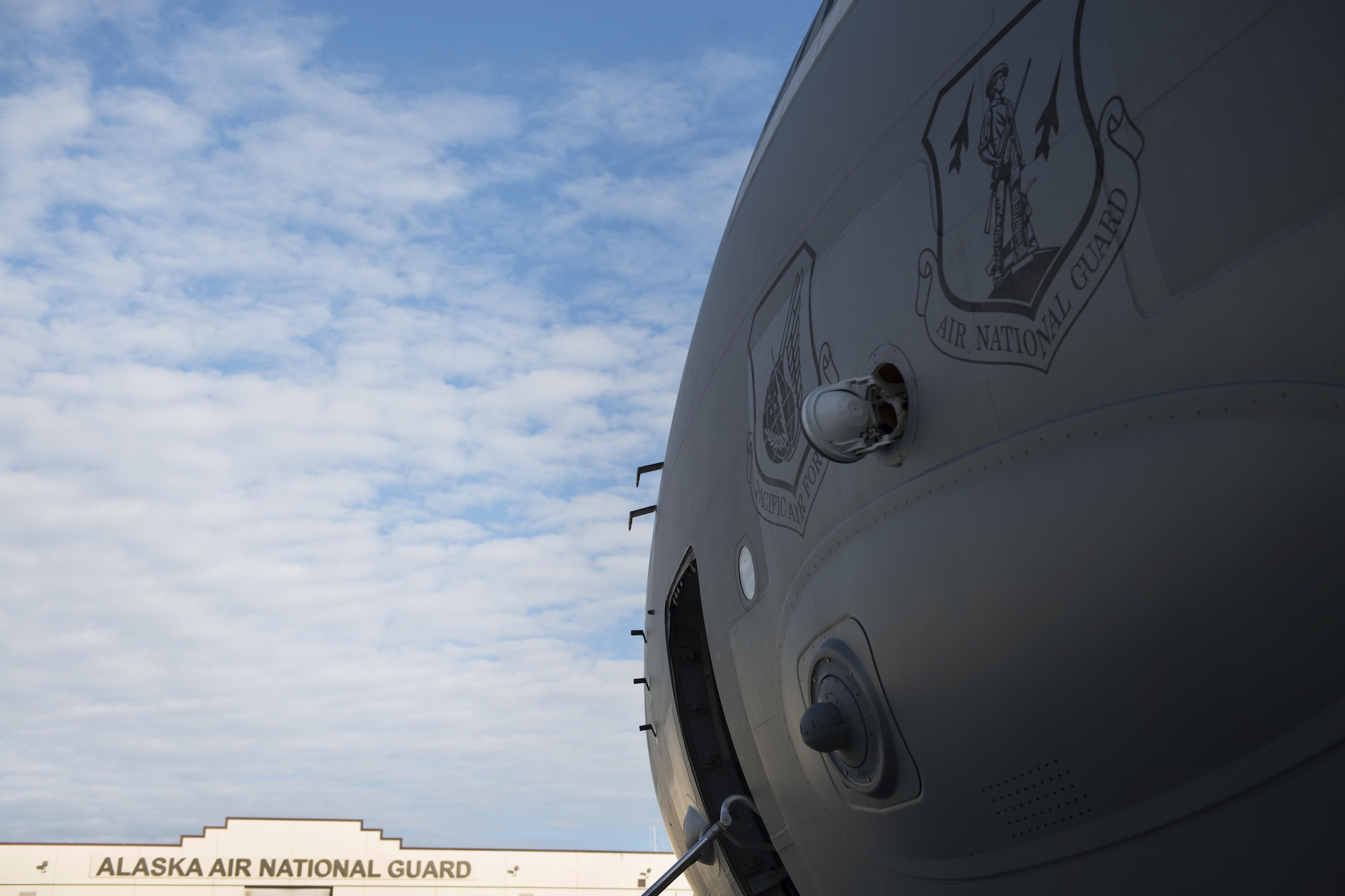 A Joint Base Elmendorf-Richardson C-17 Globemaster III rests on the flightline as Airmen of the 176th Wing, Alaska Air National Guard load cargo at JBER, Alaska, Aug. 28, 2017. The Airmen will travel to Houston, Texas as part of a humanitarian mission in response to Hurricane Harvey.