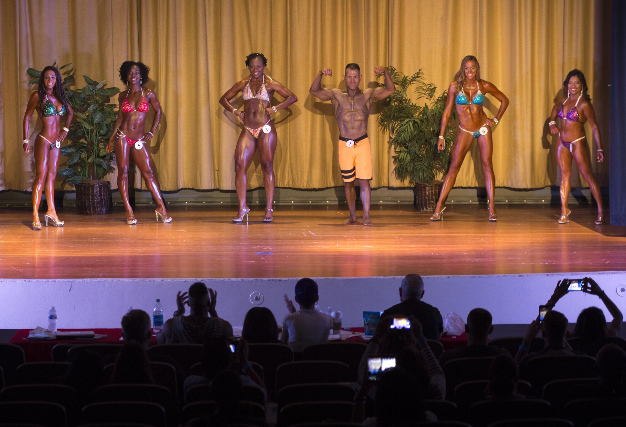 Six competitors are introduced during a bodybuilding competition at Luke Air Force Base, Ariz., Aug. 26, 2017. Each competitor chose one category, physique, figure or bikini to compete as well the overall category for male or female. (U.S. Air Force photo/Staff Sgt. Jensen Stidham)