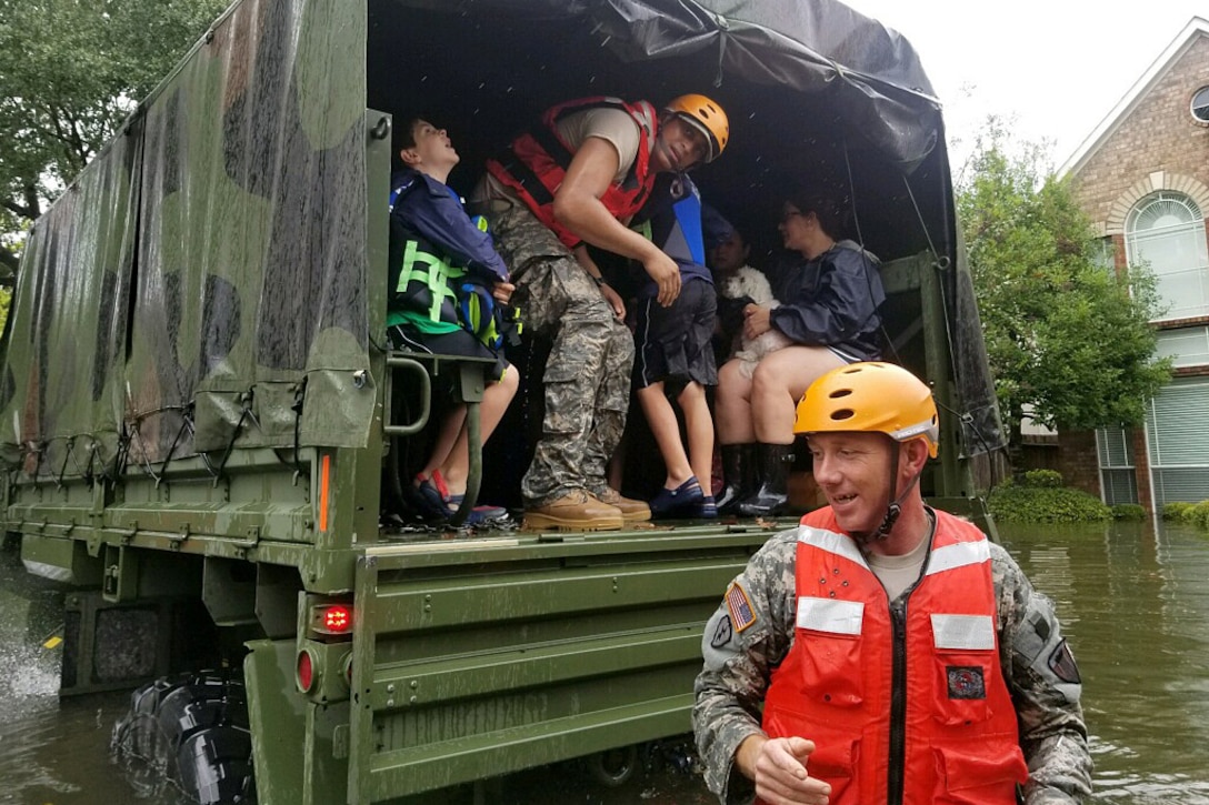 Texas Army National Guardsmen help residents affected by flooding caused by Hurricane Harvey