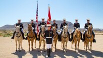 Sergeants Fernando Blancas, Jedidiah Birnie, Terry Barker, Jacob Cummins, Corporals Nicholas Davis, Alicia Frost and Javier Castellon all post with Staff Sgt. Nicholas Beberniss for a Mounted Color Guard portrait with Elephant Mountain in the background, at the stables aboard Marine Corps Logistics Base Barstow, Calif., Aug. 10. The Marine Corps is proudly celebrating the MCG's 50th year of service throughout 2017.