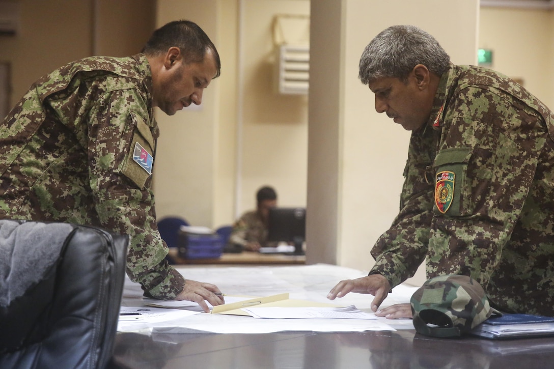 Afghan National Army soldiers with 215th Corps discuss tactics for ongoing clearing procedures during Operation Maiwand Five at Camp Shorabak, Afghanistan, Aug. 26, 2017. U.S. advisors with Task Force Southwest are assisting their Afghan counterparts throughout the operation as a means to deny safe haven to insurgency in the Nawa district of Helmand Province, Afghanistan, and promote security and Afghan governmental influence in the area. (U.S. Marine Corps photo by Sgt. Lucas Hopkins)