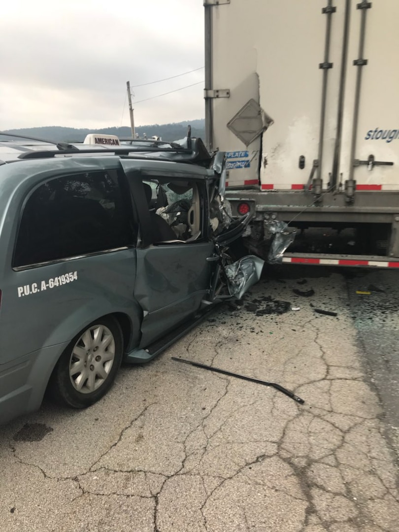 An American Taxi minivan crashes into the back of a parked tractor trailer during the early morning hours of Aug. 17, 2017.