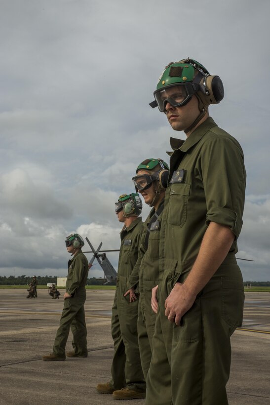 Marines from Detachment A, Marine Light Attack Helicopter Squadron 773, Marine Aircraft Group 49, 4th Marine Aircraft Wing, Marine Forces Reserve, watch as a Bell UH-1Y Venom for takes off in support of rescue missions in wake of Hurricane Harvey, Aug. 28, 2017, from Belle Chasse, Louisiana.
