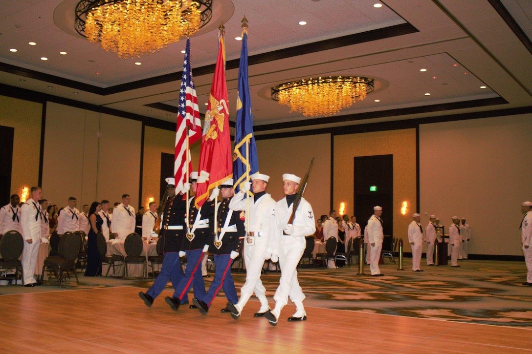 A joint color guard from Marine Corps Security Force Battalion Kings Bay, Marine Corps Security  Force Regiment, parade the colors during the opening ceremony of the  6th Annual Master at Arms Ball, hosted on Aug. 4 at the Omni Hotel, Amelia Island, Fl. More than 500 sailors celebrated this event alongside Marines stationed aboard Naval Submarine Base Kings Bay. (Courtesy phot taken by Lance Cpl. Karlin Canady/Released)