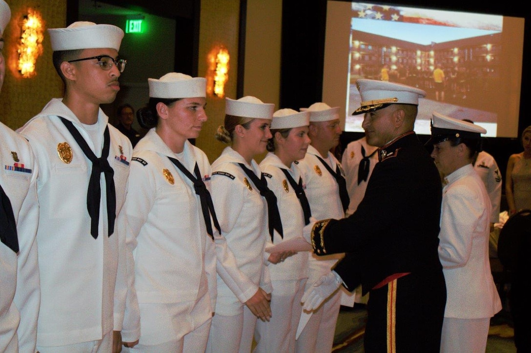 Lt. Col. David Martinez, commanding officer, Marine Crops Security Force Battalion Kings Bay, congratulates the newly promoted sailors after a frocking ceremony at the unit's 6th Annual Master at Arms Ball Aug. 4, at the Omni Hotel in Amelia Island, Fl. The ball served as an occasion to honor the 500 sailors who serve aboard Naval Submarine Base Kings Bay as masters at arms. (Courtesy photo by Lance Cpl. Karlin Canady/Released)