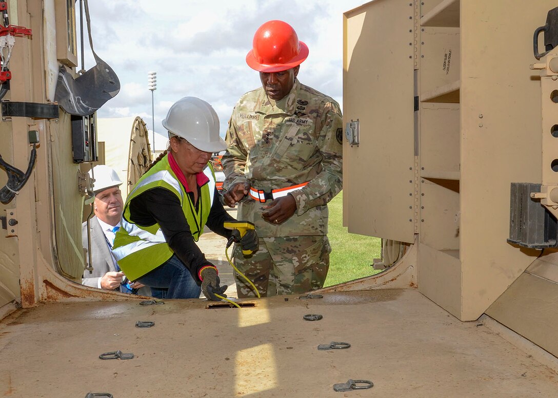 Management and Program Analyst Rebecca Smith uses a General DCS660 Seascope to perform an ammo abatement demonstration in a military vehicle for DLA Director Army Lt. Gen. Darrell Williams.