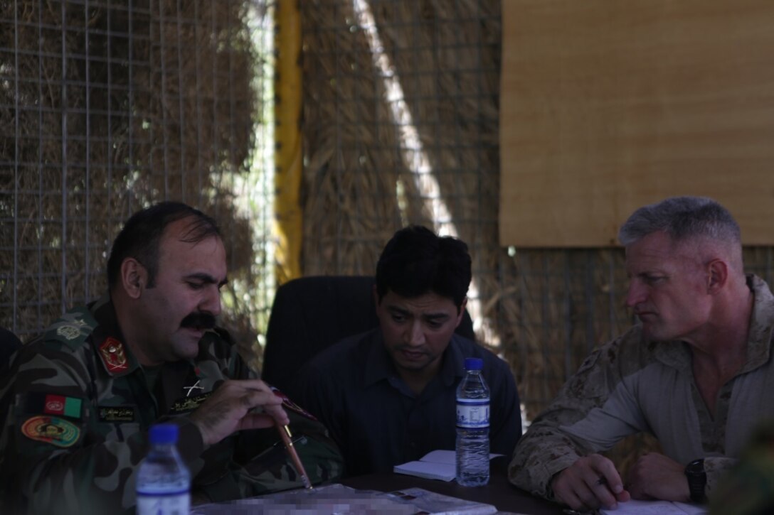Afghan National Army Brig. Gen. Wali Mohammed Ahmadzai, the commander of 215th Corps, and Brig. Gen. Roger Turner, the commanding general of Task Force Southwest, discuss plans and tactics to secure and clear the Nawa district of insurgents during Operation Maiwand Five Aug. 21, 2017. Several elements of the Afghan National Defense and Security Forces are completing clearing procedures to thwart enemy presence with assistance from U.S. advisors with the Task Force. Denying insurgency and building Afghan governmental influence helps to enhance security and stability for the local populace. (U.S. Marine Corps photo by Cpl. Tyler Harrison)