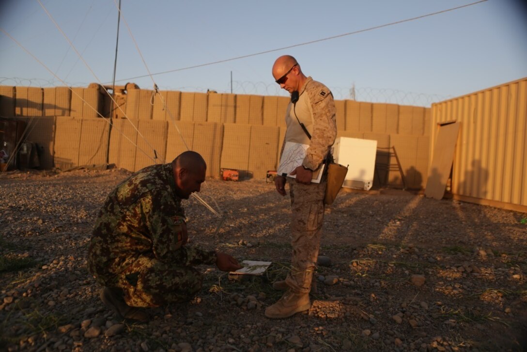 U.S. Marine Capt. John Quail, the Task Force Southwest operations advisor to Afghan National Army 215th Corps, and ANA Col. Abdul Latif, the operations officer of 215th Corps, develop plans to secure a portion of Nawa district in Helmand province during Operation Maiwand Five Aug. 21, 2017. Advisors with the Task Force are assisting their Afghan National Defense and Security Force counterparts throughout the operation as a means to deny safe havens to insurgents in Nawa and promote security and stability to the local populace. (U.S. Marine Corps photo by Cpl. Tyler Harrison)