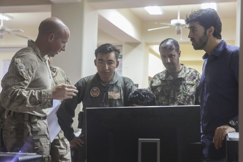 A U.S. Marine advisor with Task Force Southwest discusses tactics and plans with Afghan National Defense and Security Force personnel during Operation Maiwand Five at Camp Shorabak, Afghanistan, Aug. 26, 2017. U.S. forces and ANDSF members are collaborating throughout the operation, with Task Force advisors assisting through battle tracking their counterparts as they clear the Nawa area of enemy presence. The efforts of ANDSF help promote Afghan governmental influence and promote security and stability to the local populace. (U.S. Marine Corps photo by Sgt. Lucas Hopkins)