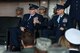 Col. Joe McFall, left, former 52nd Fighter Wing commander, fist bumps Col. Jason Bailey, right, 52nd Fighter Wing commander, while Lt. Gen. Richard Clark, 3rd Air Force commander, talks about the accomplishments of the wing during the 52nd FW change of command ceremony at Spangdahlem Air Base, Germany, Aug. 29, 2017.  Bailey assumed command of the 52nd FW from McFall. (U.S. Air Force photo by Staff Sgt. Jonathan Snyder)