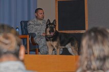 Staff Sgt. Cody Davidson, 47th Military Working Dogs patrolman, and his K-9 dog Foxo, attend a retirement ceremony for Foxo at Laughlin Air Force Base, Texas on August 25, 2017.