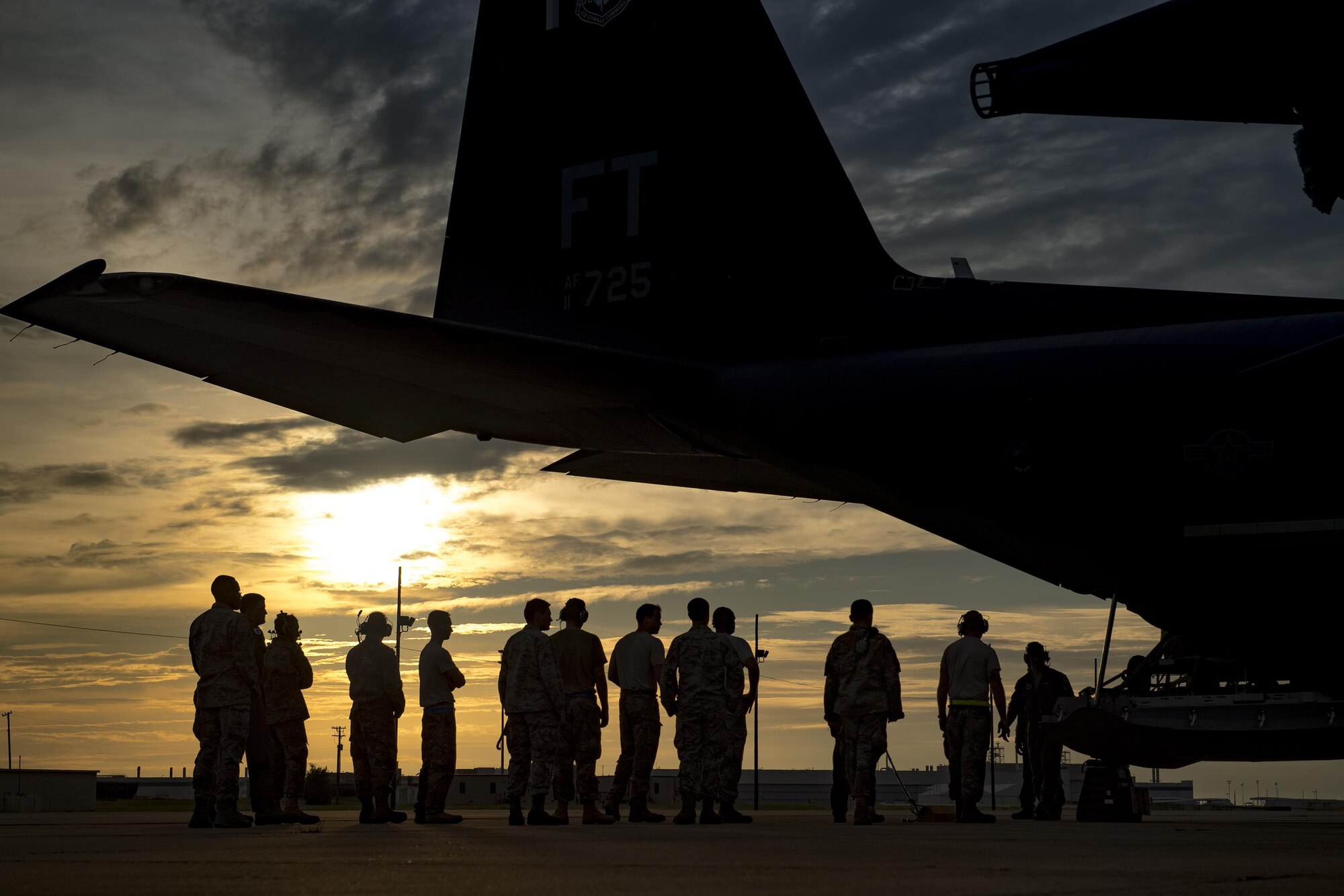 Airmen from the 23d Wing line up to assist with removing cargo from an HC-130J Combat King II, Aug. 26, 2017, at Naval Air Station Fort Worth Joint Reserve Base, Texas.