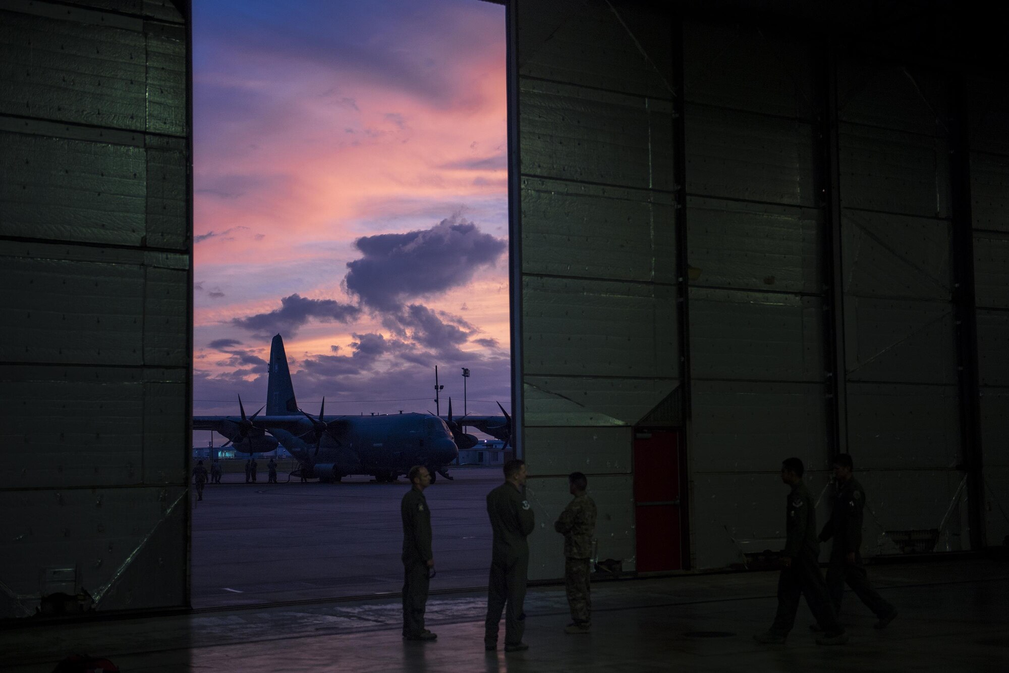 Airmen from the 23d Wing huddle in a staging hanger, Aug. 26, 2017, at Naval Air Station Forth Worth Joint Reserve Base, Texas.