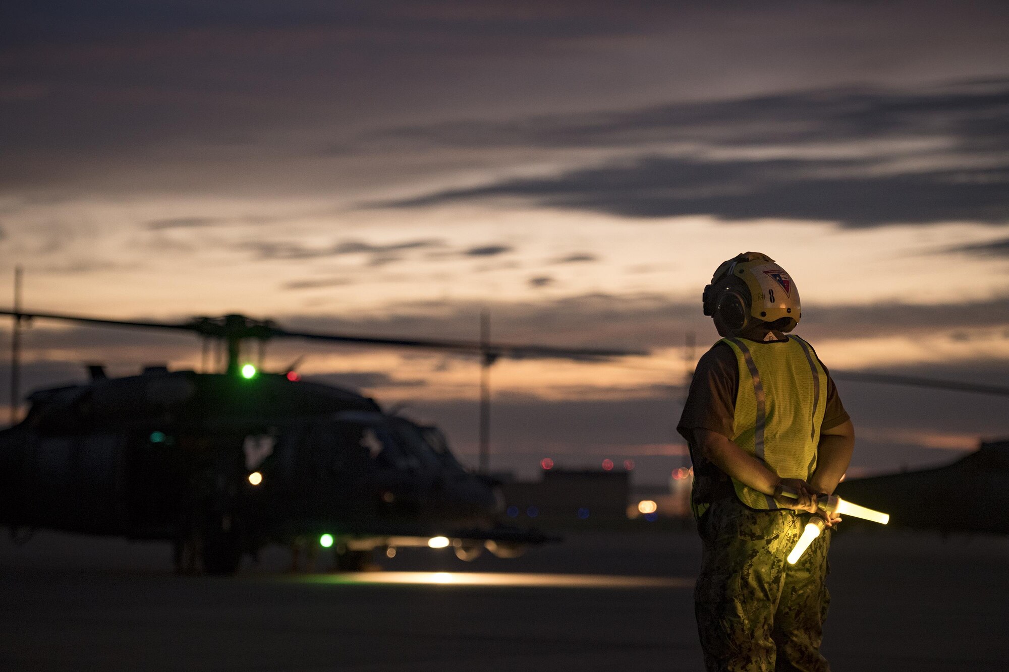 Aviation Metalsmith 2nd Class Difuntorum, marshals an HH-60G Pave Hawk from the 41st Rescue Squadron, Aug. 26, 2017, at Naval Air Station Fort Worth Joint Reserve Base, Texas.