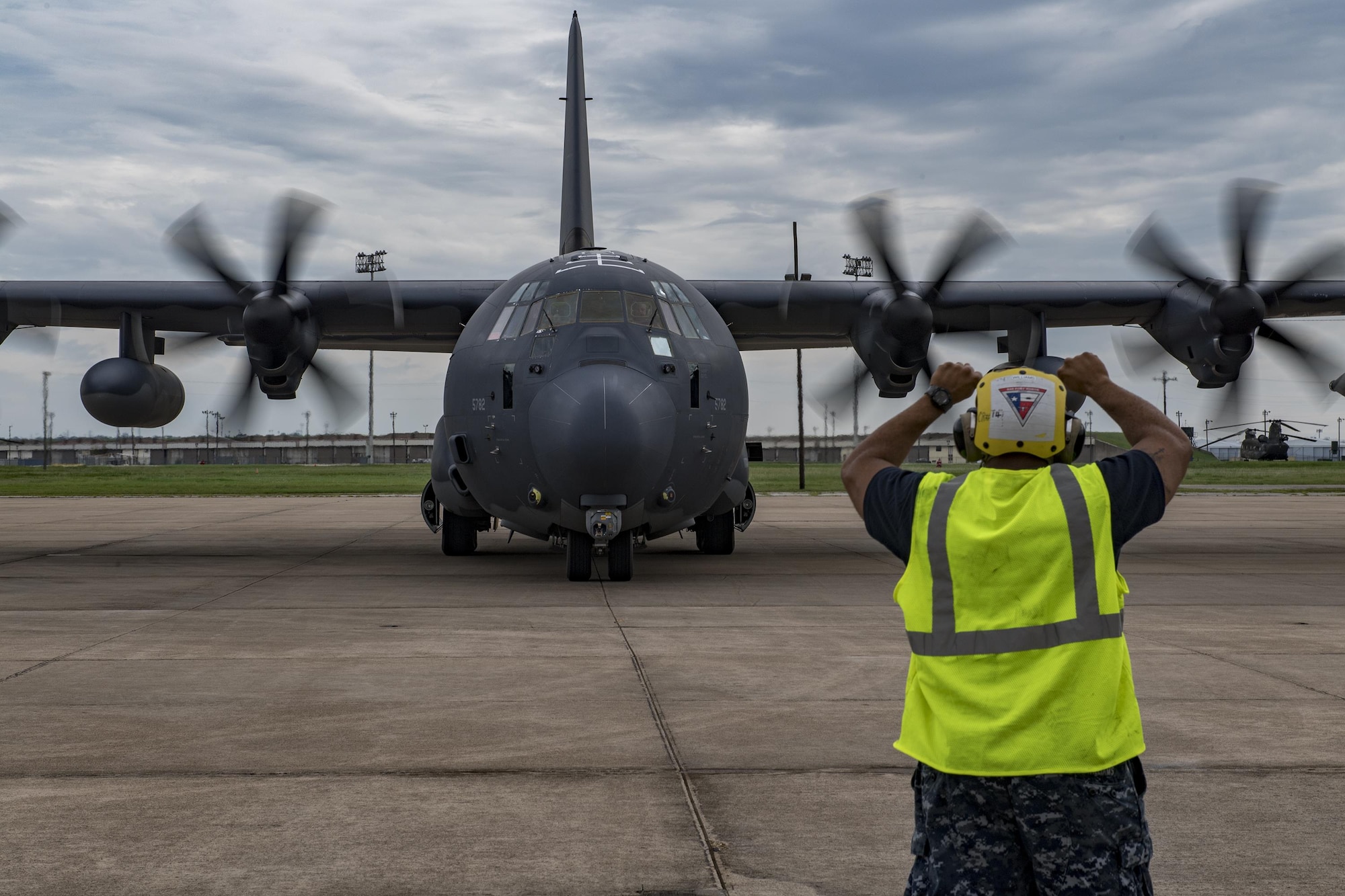A sailor assigned to Naval Air Station Fort Worth Joint Reserve Base, Texas, marshals a HC-130J Combat King II, Aug. 26, 2017.
