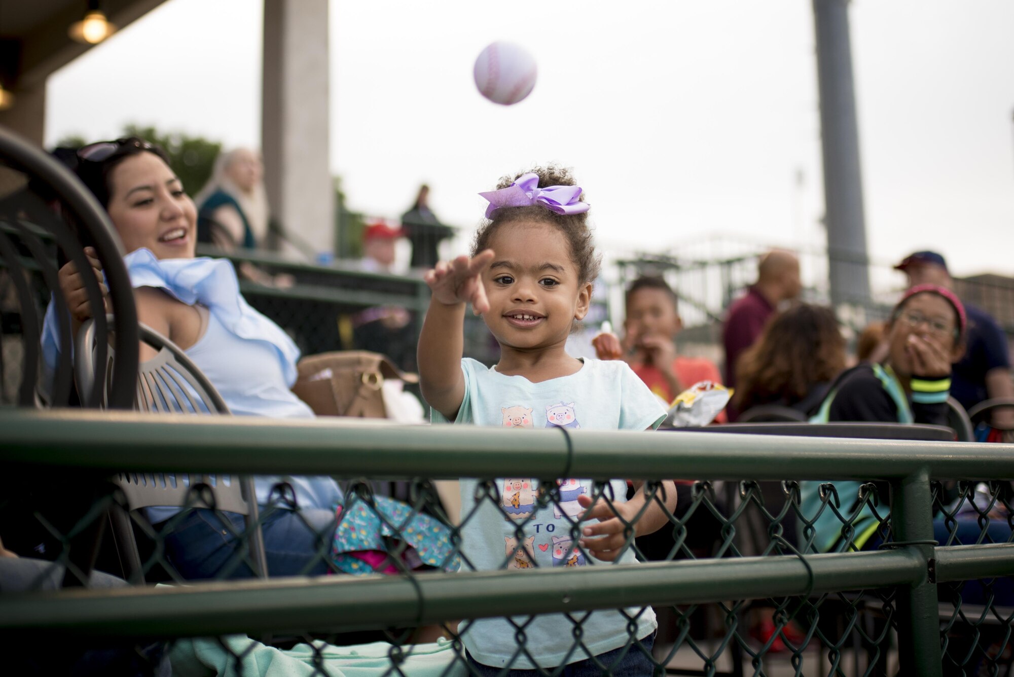 A child attending a Snowflake Event at Security Service Field throws a small toy baseball while watching a Sky Sox baseball game in Colorado Springs, Colo., Aug. 21, 2017. A Snowflake Event is a regional occurrence hosted for Snowball Express families. Since 2006, Snowball Express has provided hope and happy memories to the children of military fallen heroes who have died while on active duty since 9/11, according to the Snowball Express website. (U.S. Air Force photo by Senior Airman Dennis Hoffman)