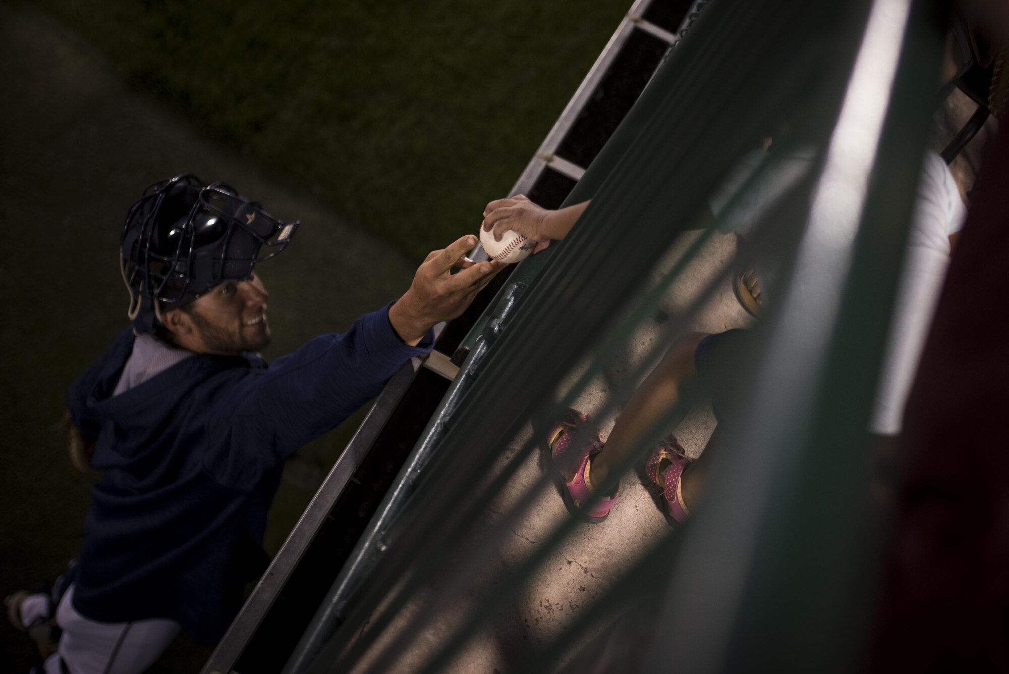 A child attending a Snowflake Event at Security Service Field reaches for a baseball during a Sky Sox baseball game in Colorado Springs, Colo., Aug. 21, 2017. The children spent the night meeting players and experiencing all the fan-fare of a minor league baseball game. (U.S. Air Force photo by Senior Airman Dennis Hoffman)