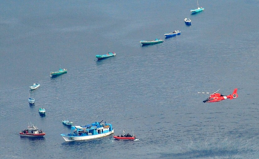 USCGC JAMES' helicopter and small boats interdicting drug smuggling vessels in the eastern Pacific Ocean.