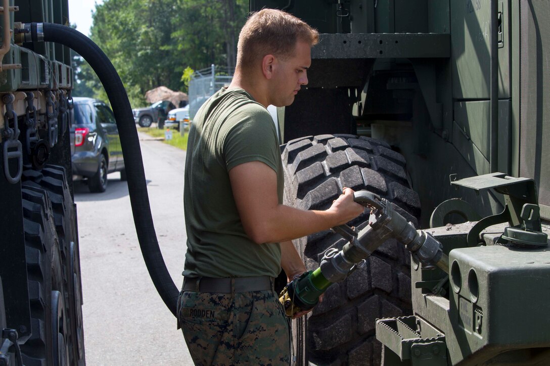 U.S. Marine Corps Cpl. Vincent  Z. Rodden, a bulk fuel specialist with Combat Logistics Battalion 26, 26th Marine Expeditionary Unit (26th MEU), refuels a Tractor, Rubber-Tired, Articulated Steering, Multi-Purpose (TRAM) 624KR during Realistic Urban Training (RUT) at Marine Corps Outlying Field Marine Corps Outlying Field Camp  Davis Training Area - South, N.C., Aug. 19, 2017.