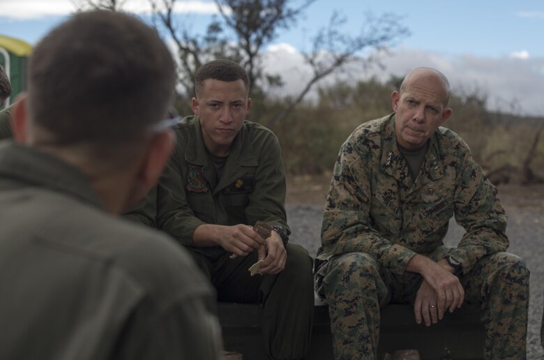 POHAKULOA TRAINING AREA, HAWAII – Lt. Col. Frank Makoski, the commanding officer of 1st Marine Aircraft Wing, confers with Lt. Gen. David Berger, the commander of U.S. Marine Corps Forces, Pacific, during a lunch with Marines from Marine Light Helicopter Assault Squadron 367 during his tour of Pohakuloa Training Area Aug. 21, 2017. Berger and a party of senior leadership met with junior Marines and leadership from various units taking part in Exercise Bougainville II, and observed day-to-day operations. Exercise Bougainville II prepares 3rd Battalion, 3rd Marine Regiment for service as a forward deployed force in the Pacific by training them to fight as a ground combat element in a Marine Air-Ground Task Force. (U.S. Marine Corps photo by Lance Cpl. Luke Kuennen)
