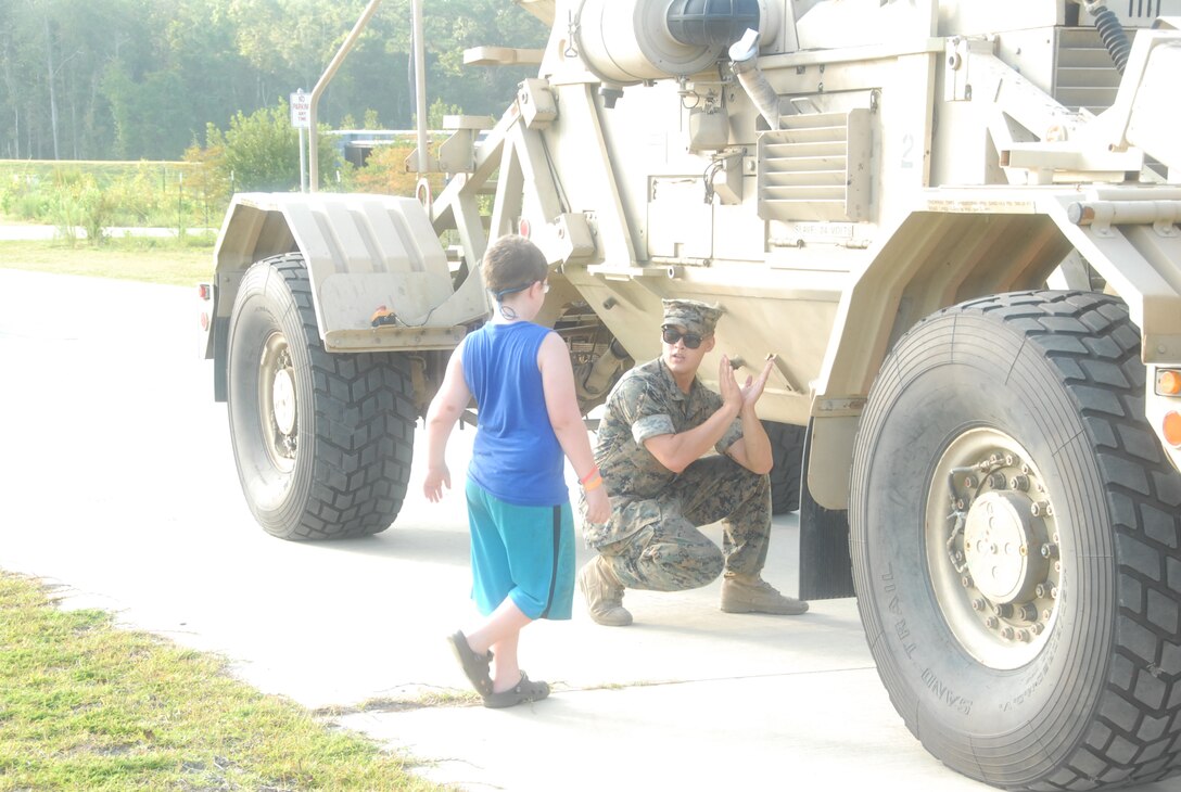 A Marine explains the V-shaped hull as part of the Static Display portion of MCES' Kids Rock Day.
