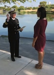 Retired Navy Cmdr. John Hill (left) swears in his granddaughter, Army 2nd Lt. Ashley Carrillo, in a commissioning ceremony July 28 at Our Lady of the Lake University in San Antonio. Carrillo joins the Army Medical Corps as a licensed clinical social worker.
