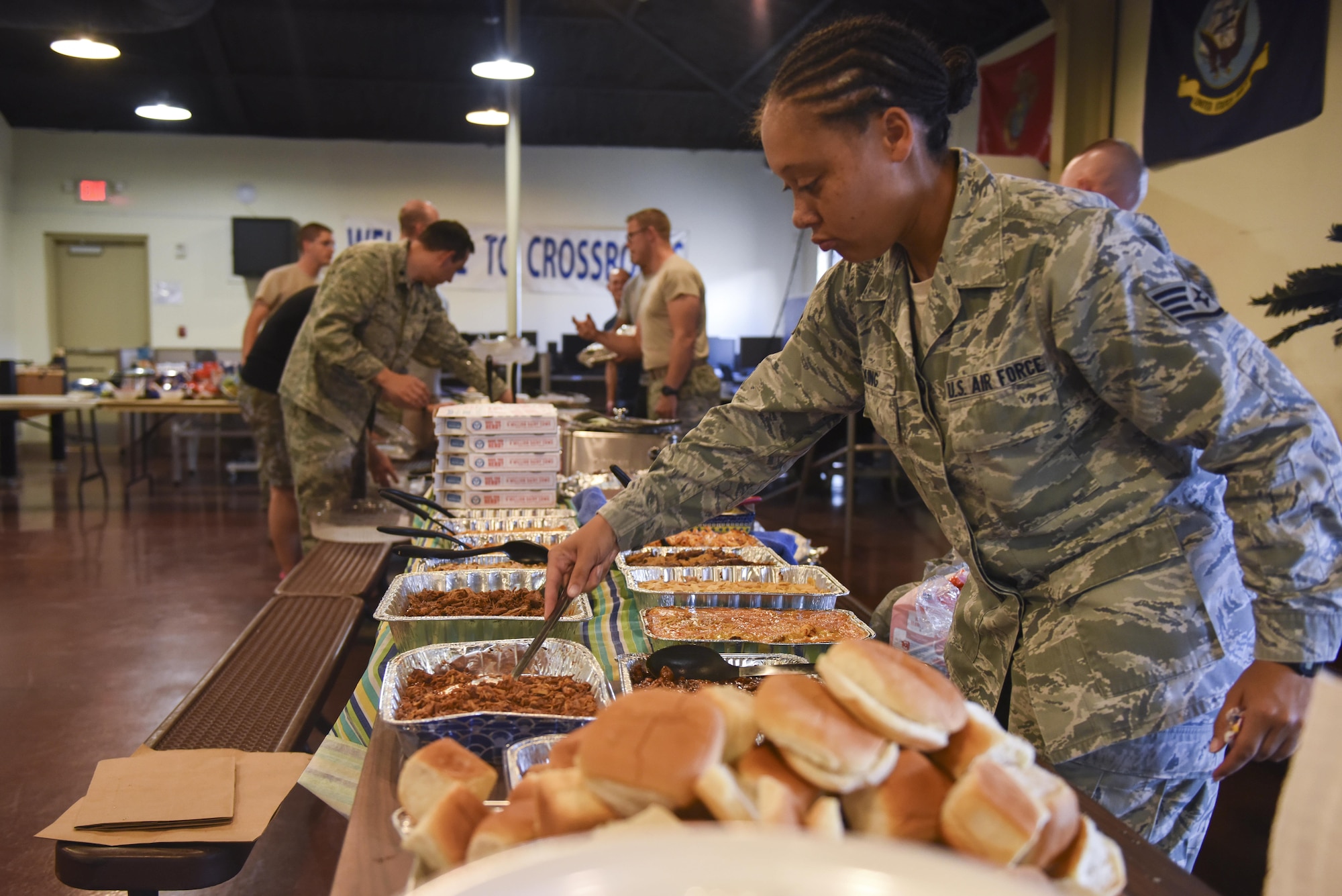 U.S. Air Force Staff Sgt. Cecile King, 315th Training Squadron instructor, lays out food for the Airmen dorm dinner at the Crossroads on Goodfellow Air Force Base, Texas, Aug. 25, 2017. The dinner showed appreciation for Airmen and was free of charge. (U.S. Air Force photo by Airman 1st Class Chase Sousa/Released)